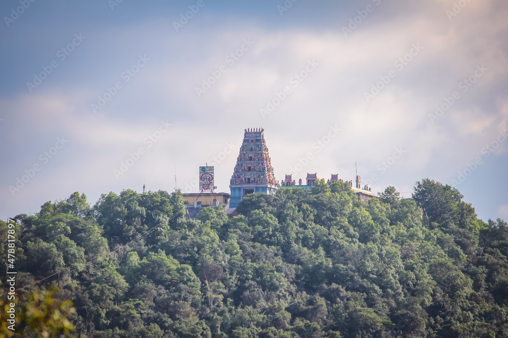 Beautiful view of the temple tower of an Hindu god over an hilltop. English Translation: Om