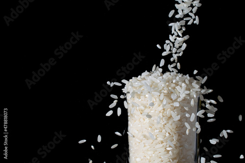 white rice poured into a glass, splash
