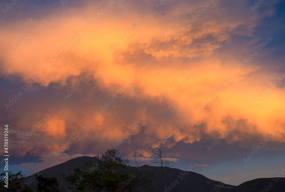 A huge mammatus cumulus cloud floating over the Iguaque mountain at sunset, near the colonial town of Villa de Leyva in central Colombia. A huge mammatus cumulus cloud floating over the Iguaque mountain at sunset, near the colonial town of Villa de Leyva in central Colombia.