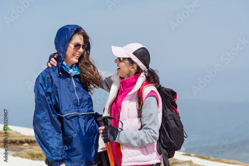 Happy Mother and Daughter in the Snowy Winter Mountain .Winter Family Vacation Concept 