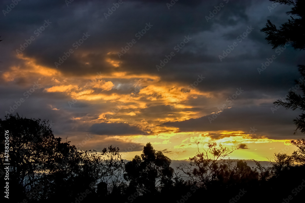 Obraz premium Orange and yellow afterglow in the eastern Andes range of central Colombia near the colonial town of Villa de Leyva in the department of Boyaca.