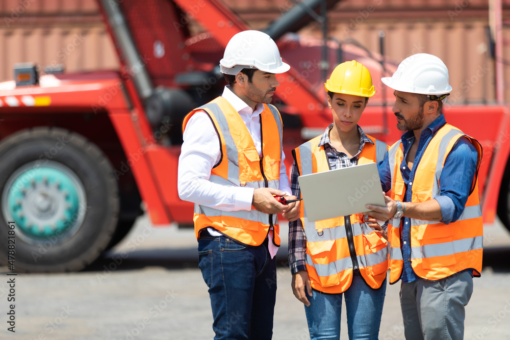 © NVB Stocker - Hispanic man harbor worker talking on the walkie-talkie radio and control loading containers at container warehouse. container yard port of import and export goods © NVB Stocker - Hispanic man harbor worker talking on the walkie-talkie radio and control loading containers at container warehouse. container yard port of import and export goods