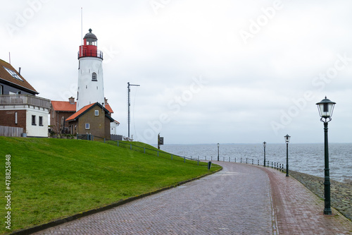 White lighthouse in the Dutch fishing village Urk. photo