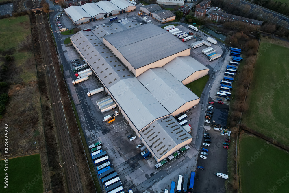 Aerial drone view of group of large modern industrial warehouse or factory buildings in suburban city area.Logistic transportation cargo terminal Aerial drone view of group of large modern industrial warehouse or factory buildings in suburban city area.Logistic transportation cargo terminal