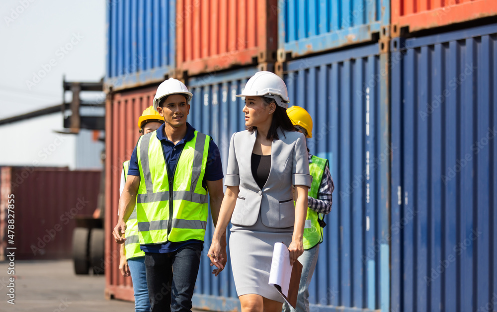 Group of professional dock worker and engineering people wearing hardhat safety helmet and vest working at container yard port of import export. Business teamwork concept Group of professional dock worker and engineering people wearing hardhat safety helmet and vest working at container yard port of import export. Business teamwork concept