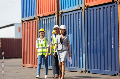 Group of professional dock worker and engineering people wearing hardhat safety helmet and vest working at container yard port of import export. Business teamwork concept © NVB Stocker