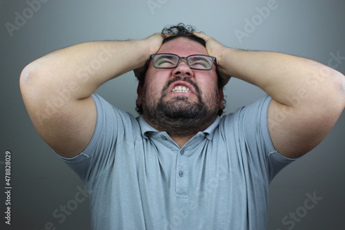 stressful male screams in panic, closes eyes in terror, keeps hands on head, finds out terrified news or disaster