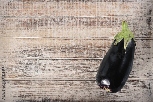 black eggplant on a wooden background - top view