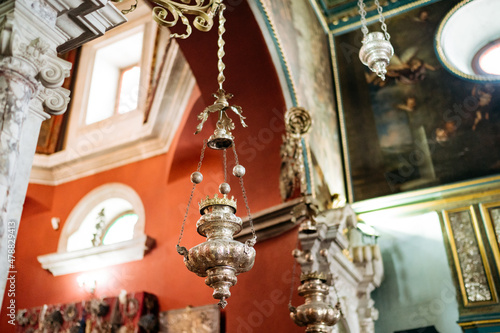 Censers hang on chains from the ceiling in the Church of Our Lady of the Rocks