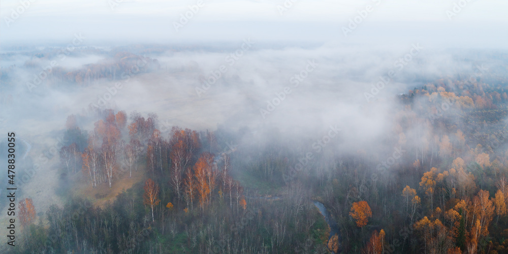 Autumn dawn over foggy forest and river aerial drone view