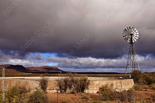Photography Windmill and water reservoir in the Karoo landscape in South Africa