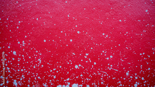 Red cement wall with splash...