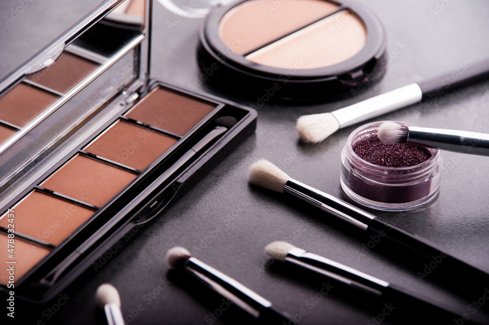 Cosmetic palette with brushes lies on a black background
Cosmetic palette with brushes lies on a black background