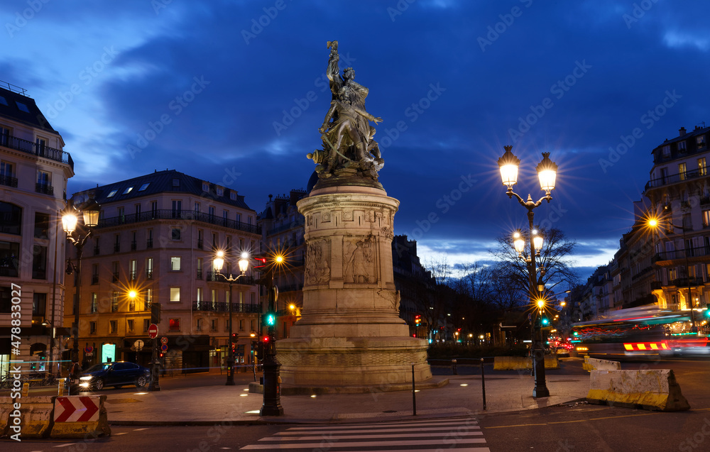 Place de Clichy at night, Paris, France. Bronze statue of Marechal Moncey at the centre of the square.