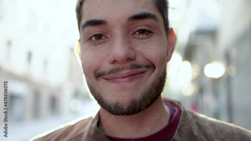 Authentic shot of hipster young man looking and smiling at camera Authentic shot of hipster young man looking and smiling at camera
