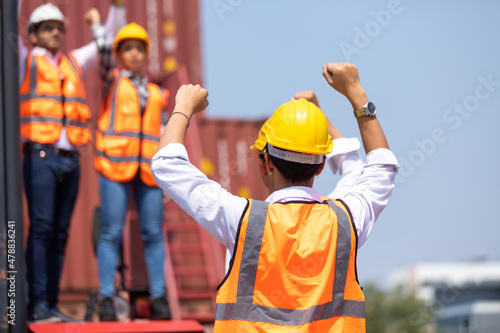 Strike of workers in container yard. Group of multiethnic engineer people during a protest in workplace