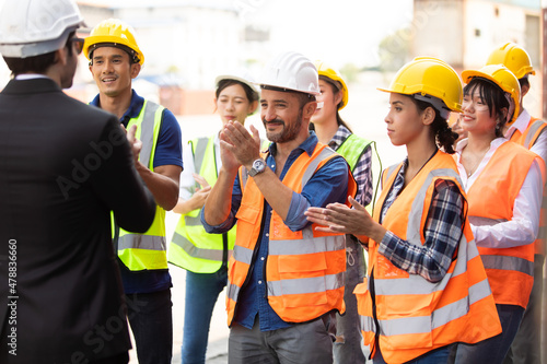 Unity and teamwork concept. Container worker audience applauding in morning brief meeting before going to work. Congratulation Celebrate success concept. photo