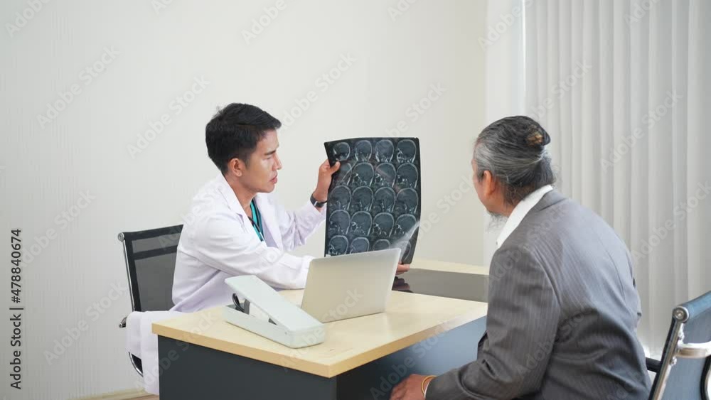 asian doctor interpret mri brain result to senior patient who visit at hospital clinic asian doctor interpret mri brain result to senior patient who visit at hospital clinic