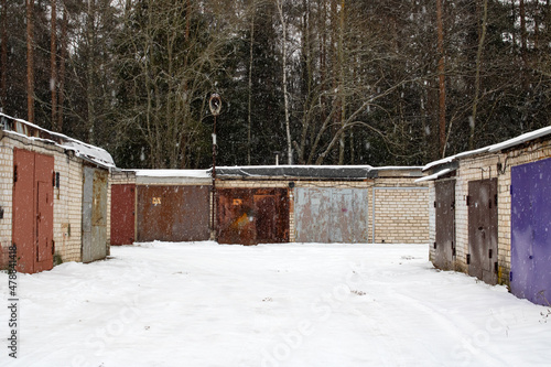 Garage doors in a row in the snow © Vera Aksionava
