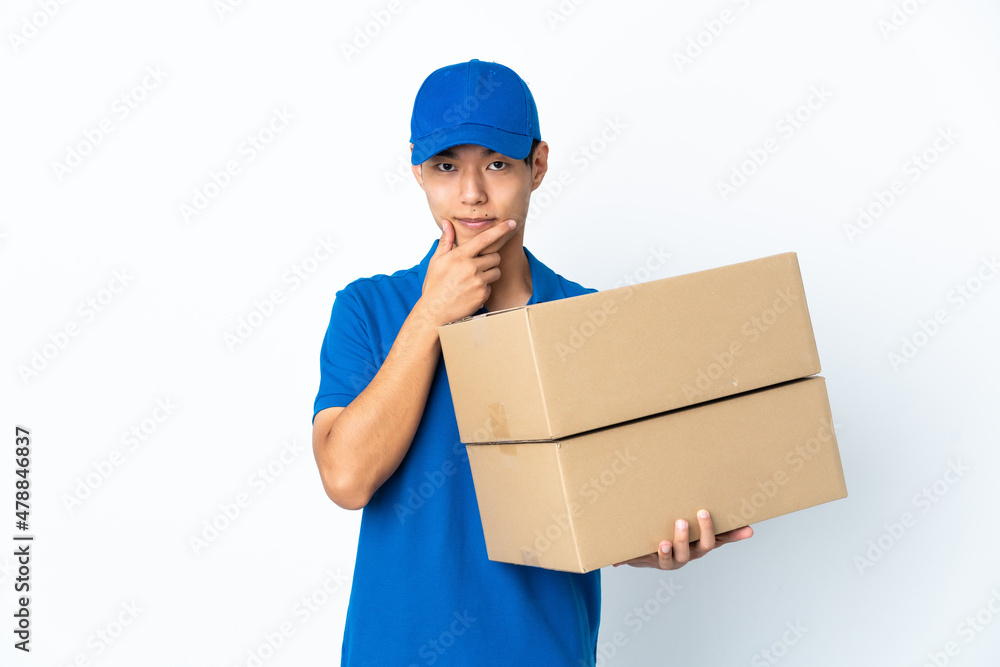 Delivery Chinese man isolated on white background thinking Delivery Chinese man isolated on white background thinking