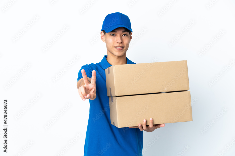 Delivery Chinese man isolated on white background smiling and showing victory sign Delivery Chinese man isolated on white background smiling and showing victory sign
