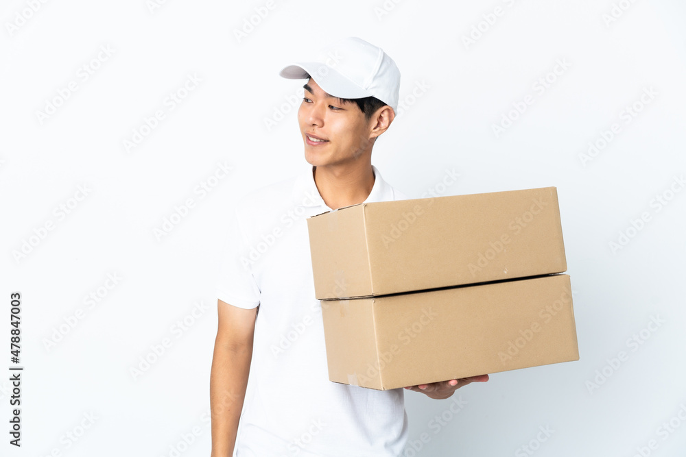 Delivery Chinese man isolated on white background looking to the side and smiling Delivery Chinese man isolated on white background looking to the side and smiling