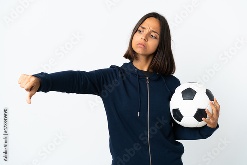 Young football player woman isolated on white background showing thumb down with negative expression © luismolinero