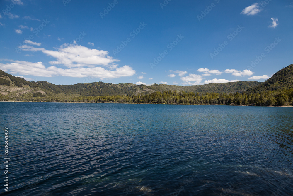 Scenic view of lake and mountains against clear blue sky, horizontal photo