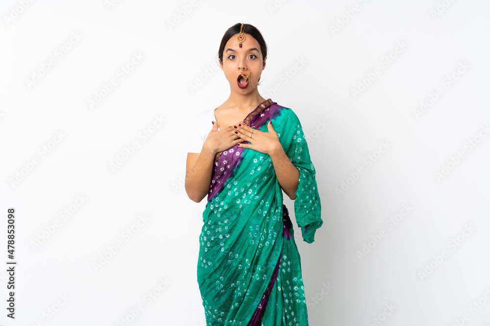 Young indian woman isolated on white background surprised and shocked while looking right Young indian woman isolated on white background surprised and shocked while looking right