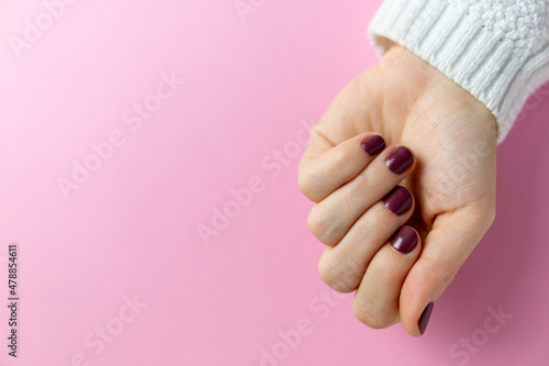 Hand on background showing freshly painted nails