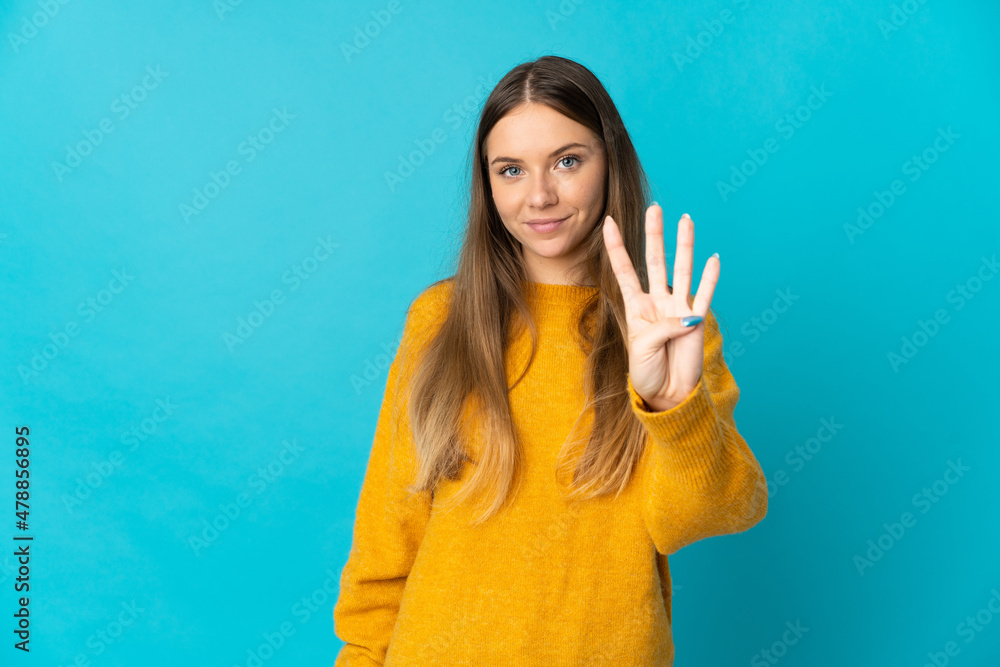 Young Lithuanian woman isolated on blue background happy and counting four with fingers Young Lithuanian woman isolated on blue background happy and counting four with fingers