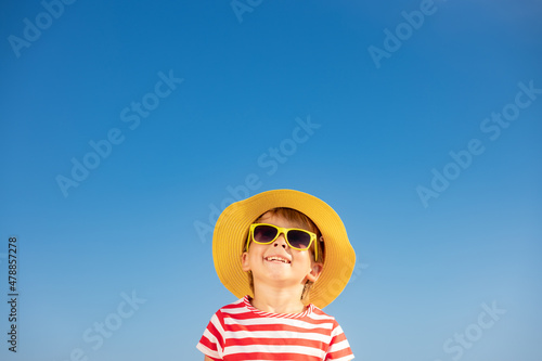 Obraz na plátne Happy child having fun outdoor against blue sky