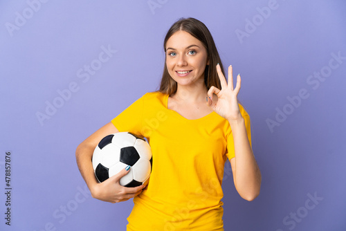 Young Lithuanian football player woman isolated on purple background showing ok sign with fingers © luismolinero