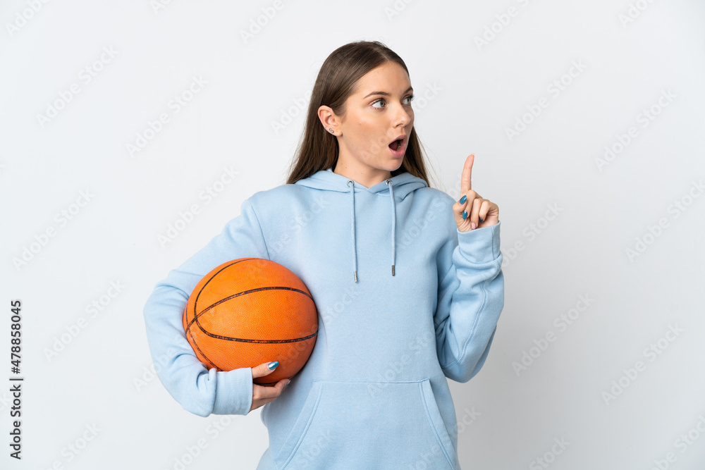 Young Lithuanian woman playing basketball isolated on white background thinking an idea pointing the finger up Young Lithuanian woman playing basketball isolated on white background thinking an idea pointing the finger up