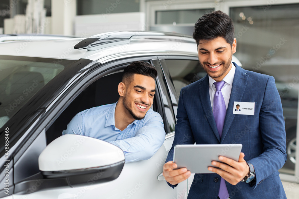 Rich middle-eastern guy businessman visiting car salon Rich middle-eastern guy businessman visiting car salon