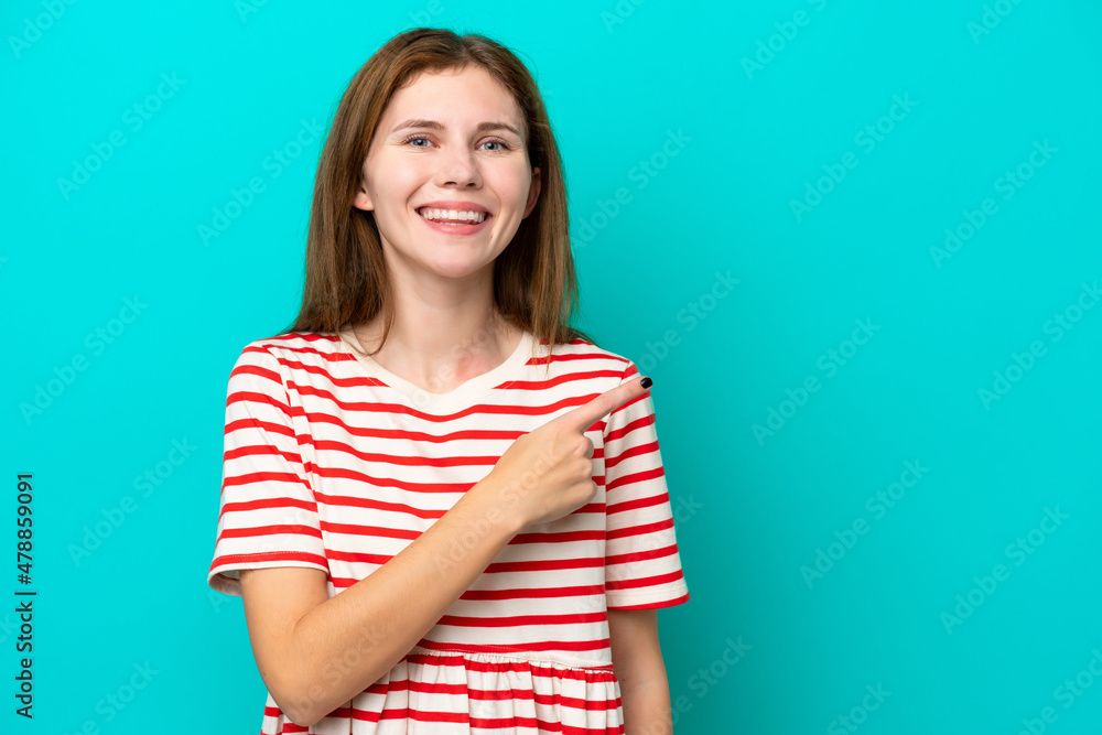Young English woman isolated on blue background pointing to the side to present a product Young English woman isolated on blue background pointing to the side to present a product