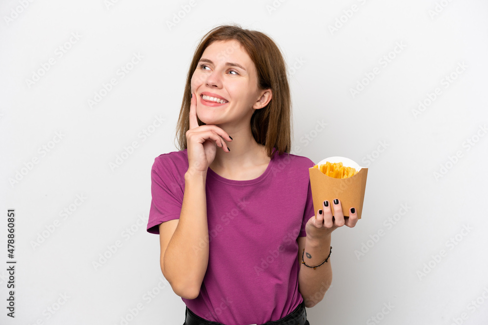 Young English woman holding fried chips isolated on white background thinking an idea while looking up Young English woman holding fried chips isolated on white background thinking an idea while looking up