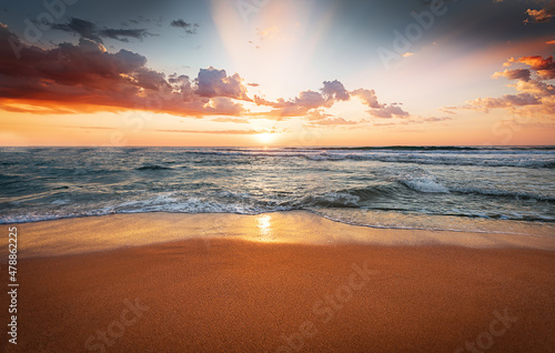 Fototapeta Naklejka Na Ścianę i Meble -  Colorful ocean beach sunrise.  Natural landscape and sun rising at skyline.