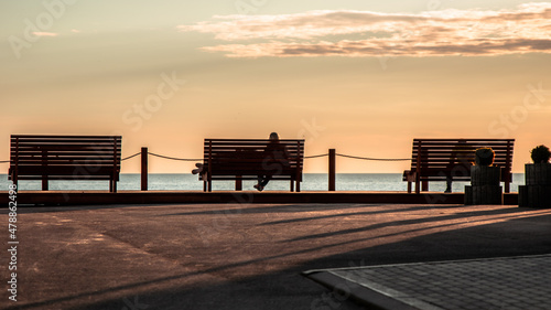 Sunset in the beach and people sitting on the bench © Matas Mačiulskis