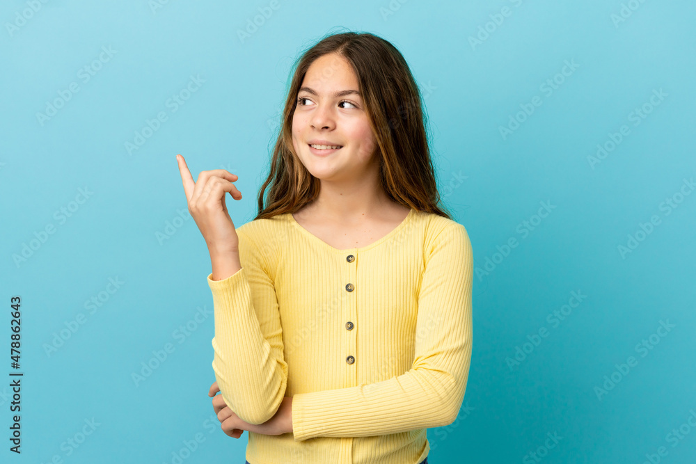 Little caucasian girl isolated on blue background pointing up a great idea Little caucasian girl isolated on blue background pointing up a great idea
