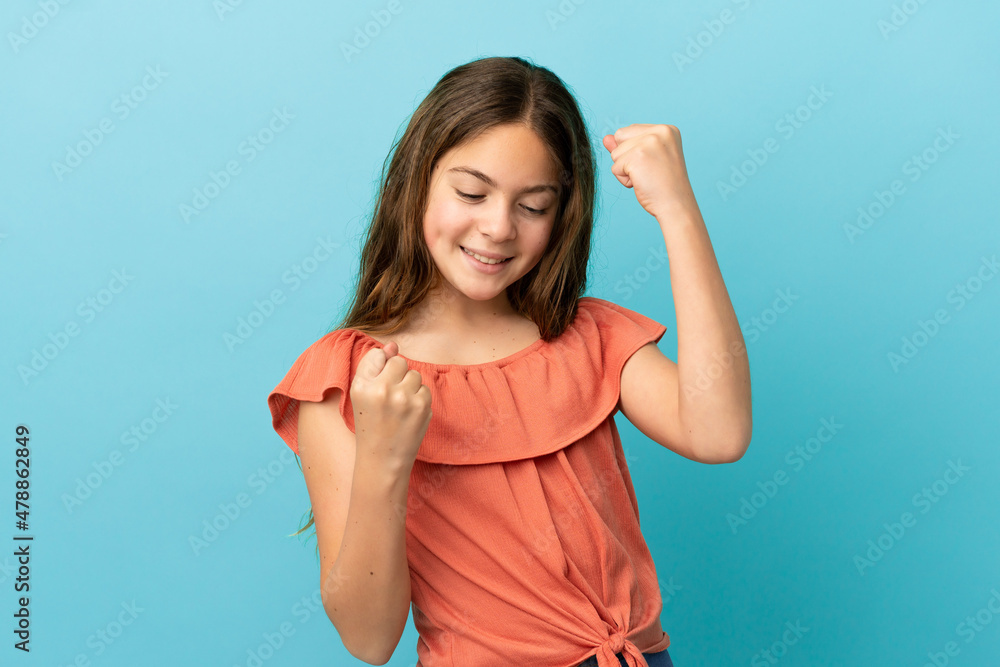 Little caucasian girl isolated on blue background celebrating a victory Little caucasian girl isolated on blue background celebrating a victory