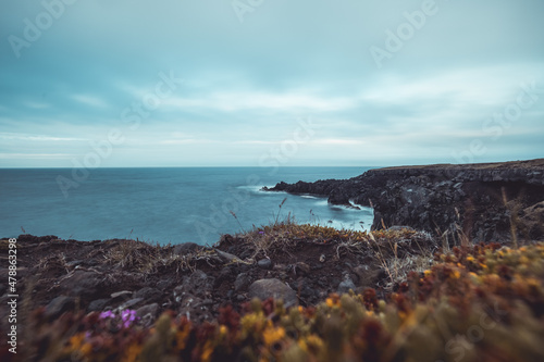  Basalt rock formations and cliffs on Hellnar region of Iceland on a cloudy day in summer. Majestic views over cliffs on Iceland photo