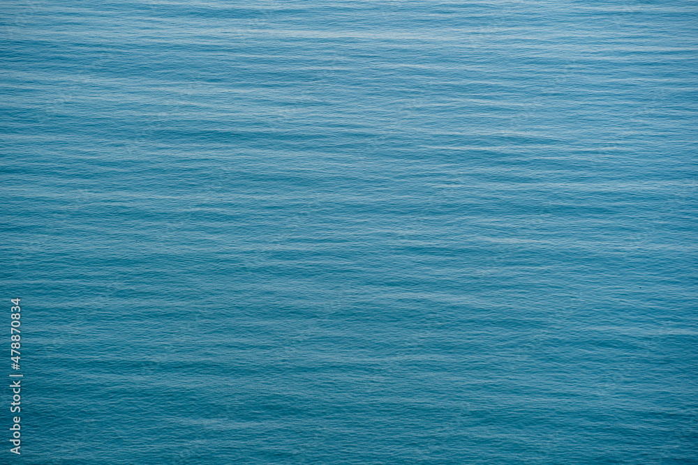Fototapeta premium Blue sea water surface with waves, top view
