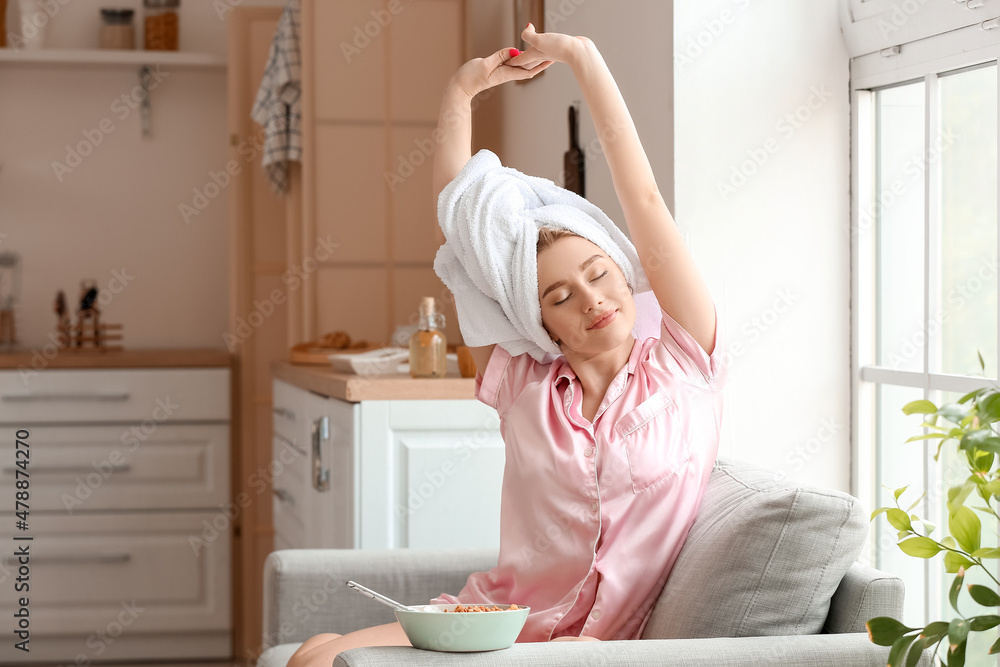 Pretty young woman stretching in sofa after shower Pretty young woman stretching in sofa after shower