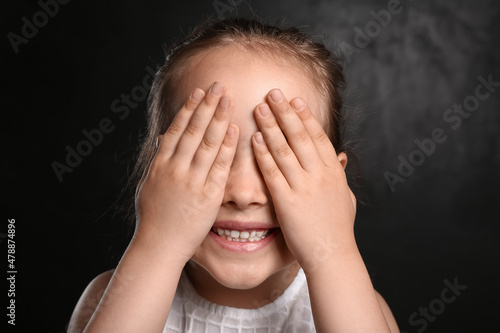 Cute little girl closing ey...