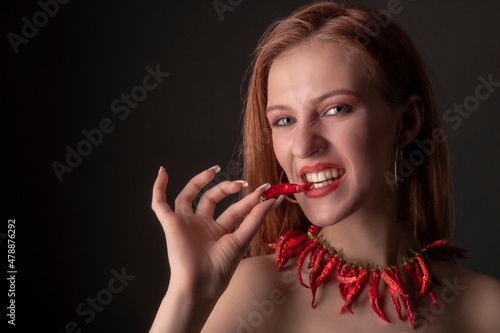 Beautiful Young Smiling Woman Holding Red Hot Chili Pepper.