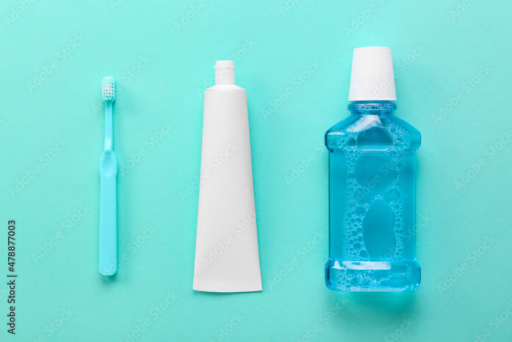 Tube with tooth paste, brush and mouthwash on color background Tube with tooth paste, brush and mouthwash on color background
