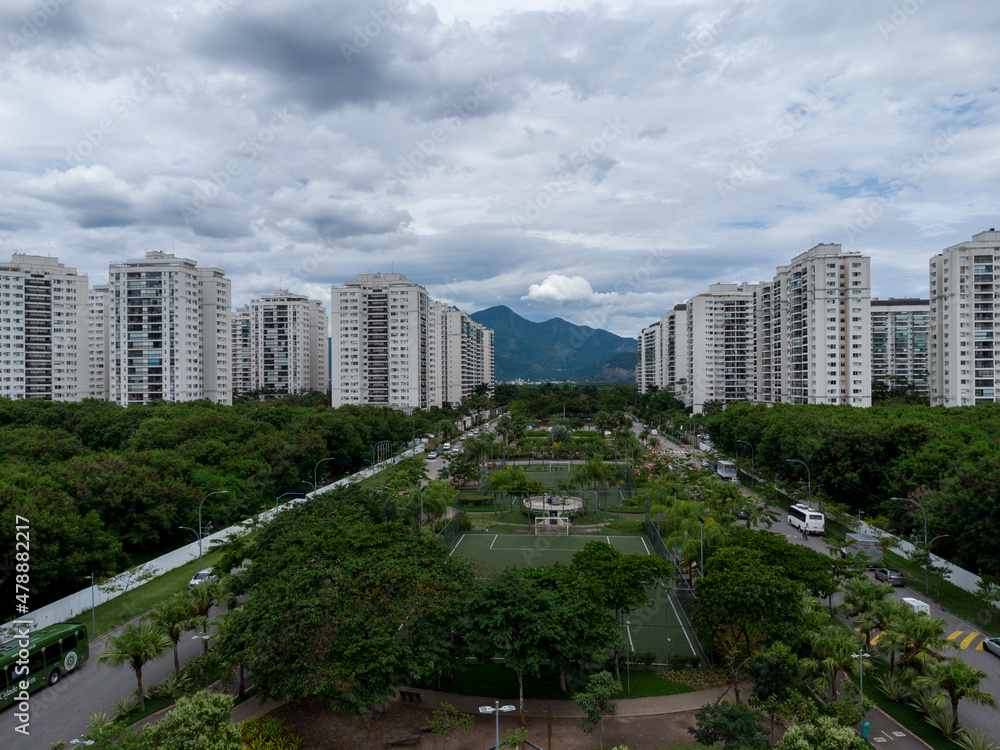 Aerial view of Cidade Jardim, in Jacarépagua in Rio de Janeiro, Brazil. Residential buildings and mountains in the background. Cloudy day. Drone photo