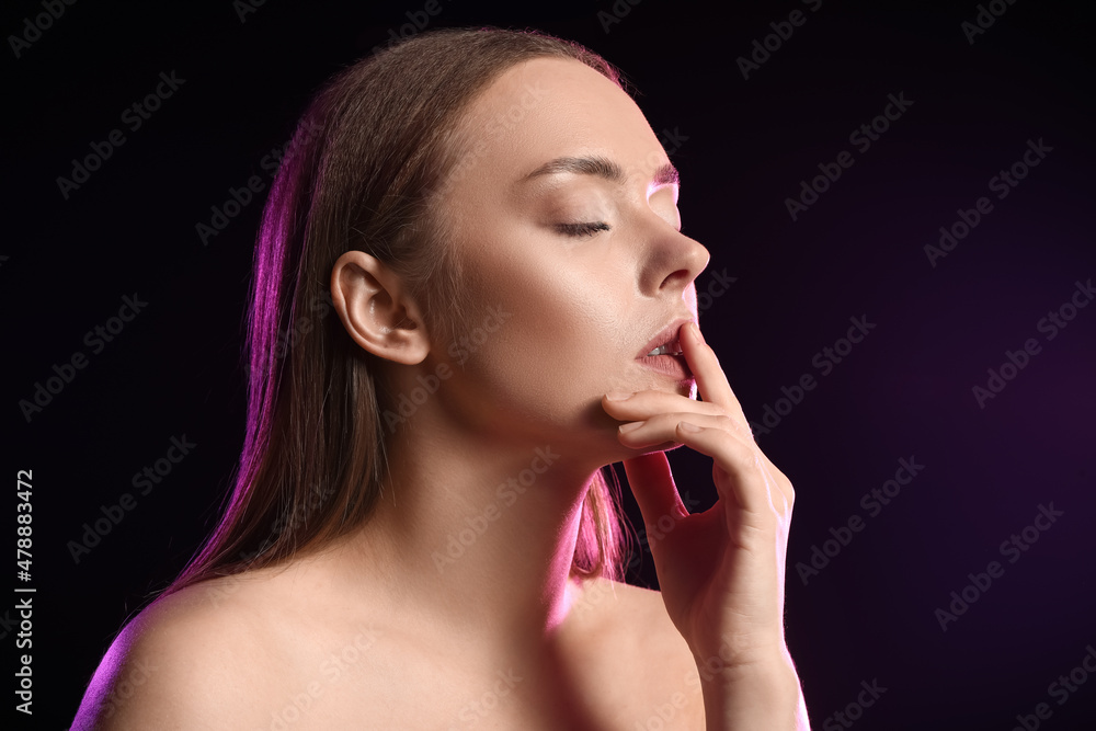 Toned portrait of attractive young woman on black background Toned portrait of attractive young woman on black background