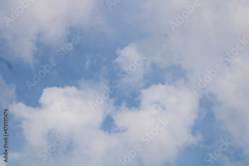 Fluffy White Clouds In The Blue Sky On A Bright Sunny Day. 